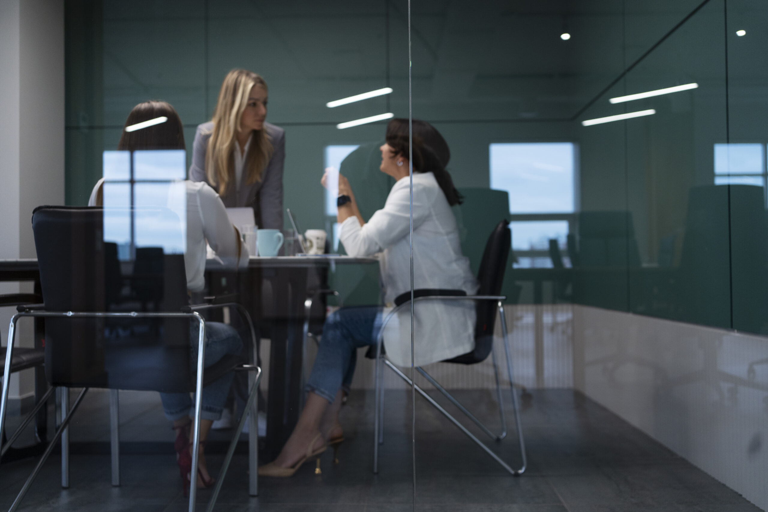 3 woman sitting in an office space